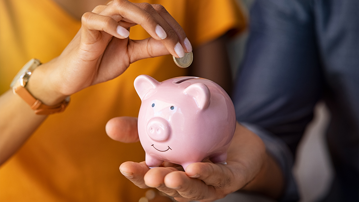 Hands holding a piggy bank