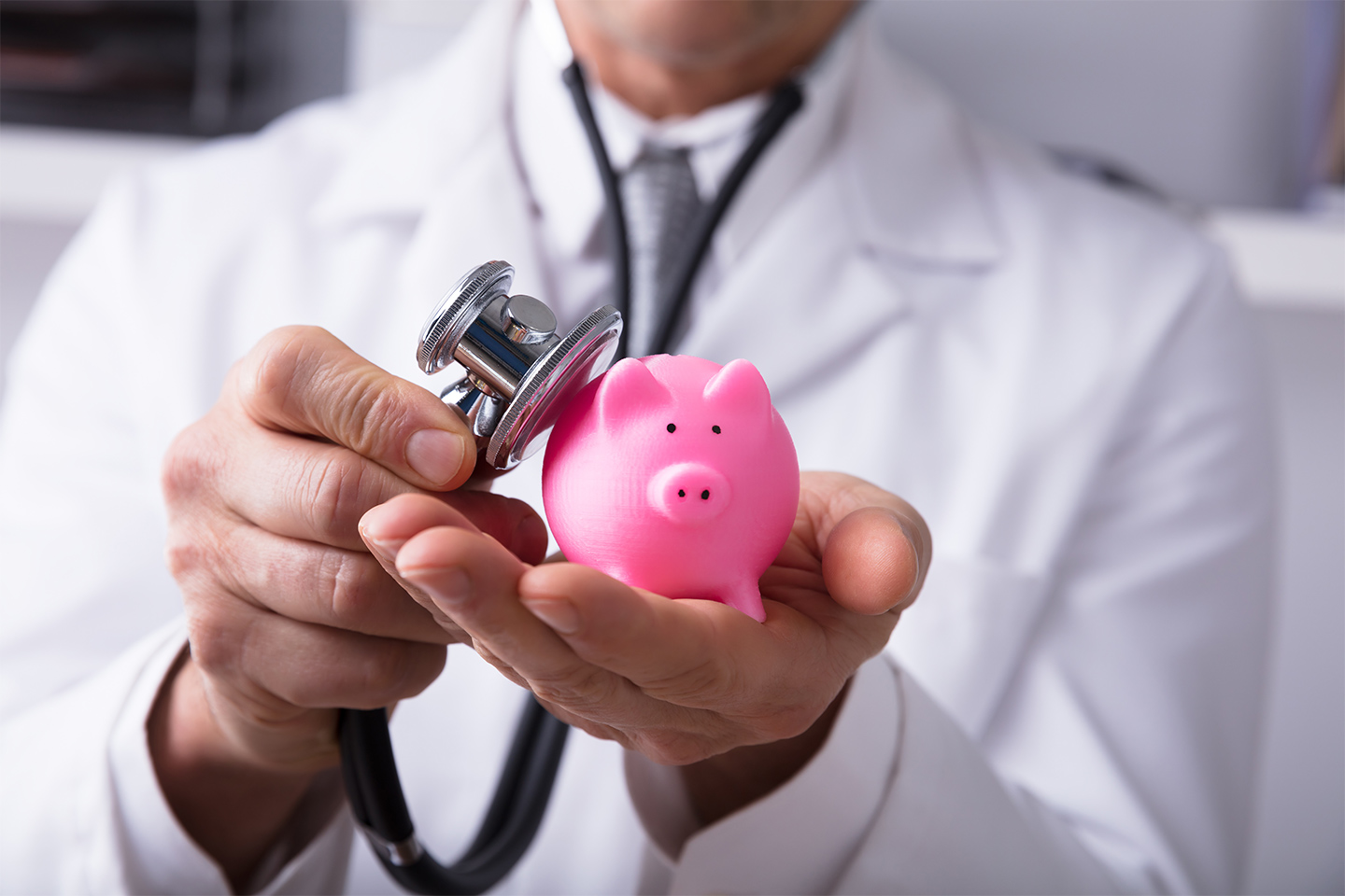 Piggy bank in a doctor's hands with a stethoscope