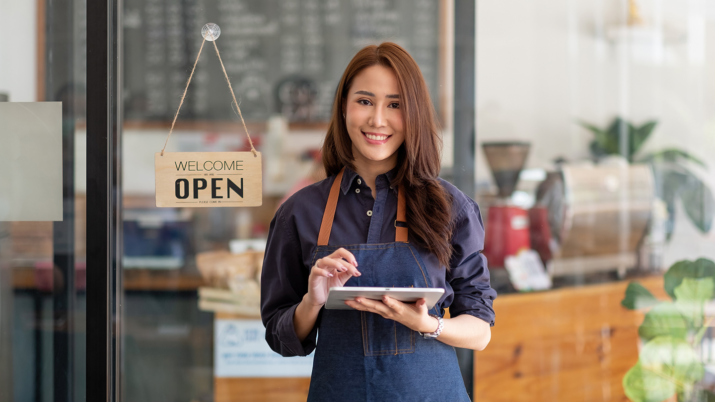 Small business owner standing storefront